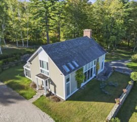 Guest house on the grounds of 209 Blue Hill Road estate surrounded by landscaped lawns and Berkshire scenery.